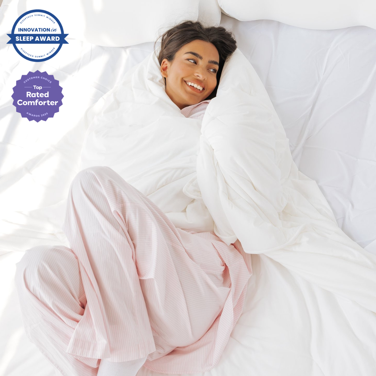 A woman resting cool and comfortably wrapped in the award-winning white CloudSoft cooling comforter